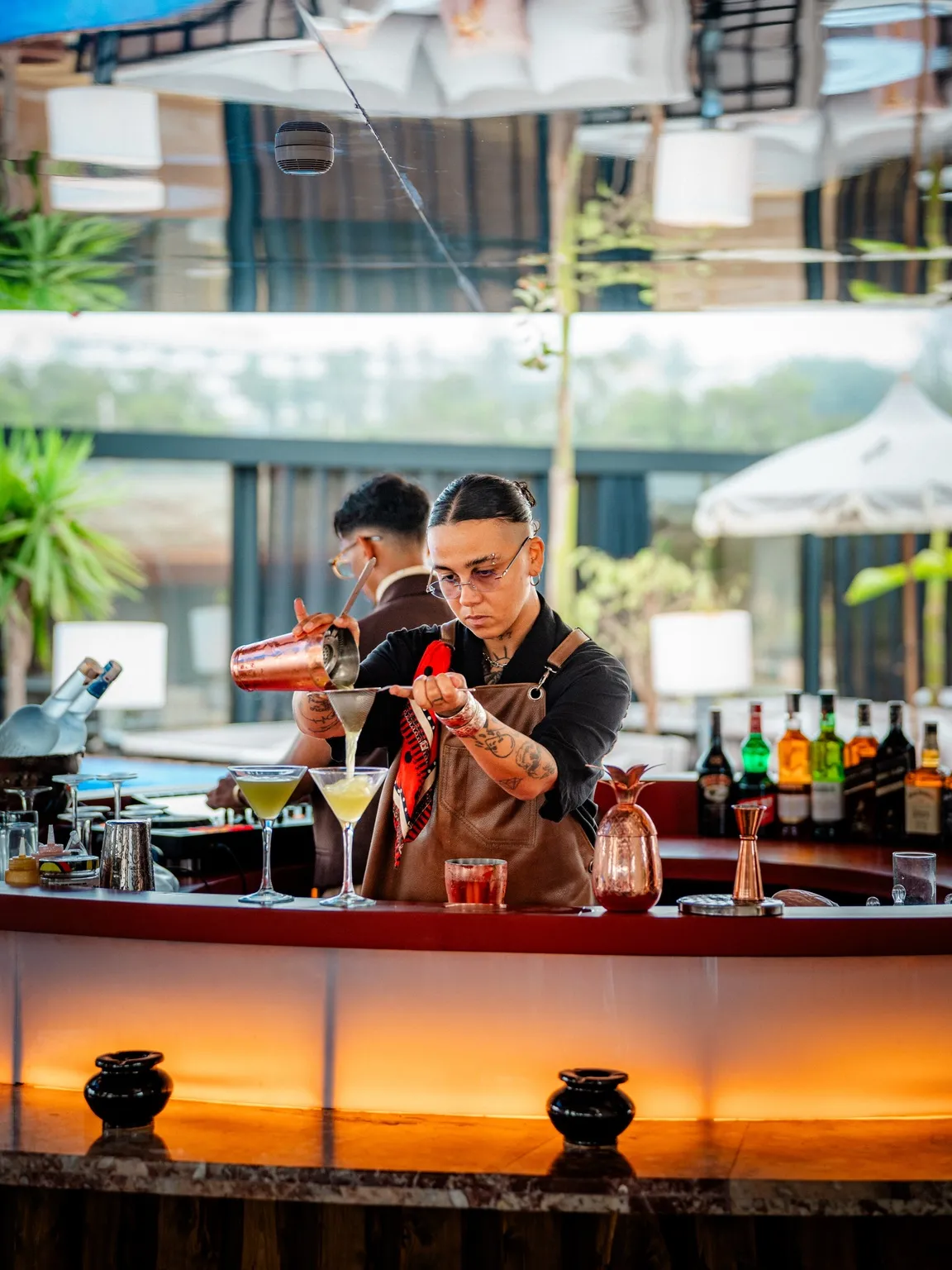 A bartender pouring drinks at Coup de Foudre Agadir