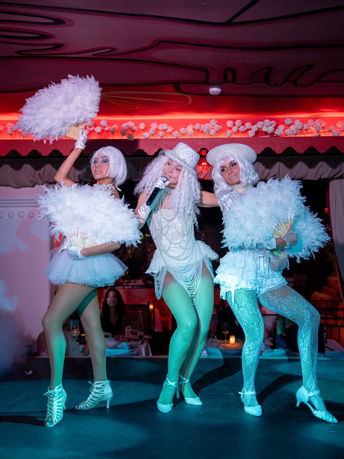 Cabaret dancers in feathered costume at Coup de Foudre