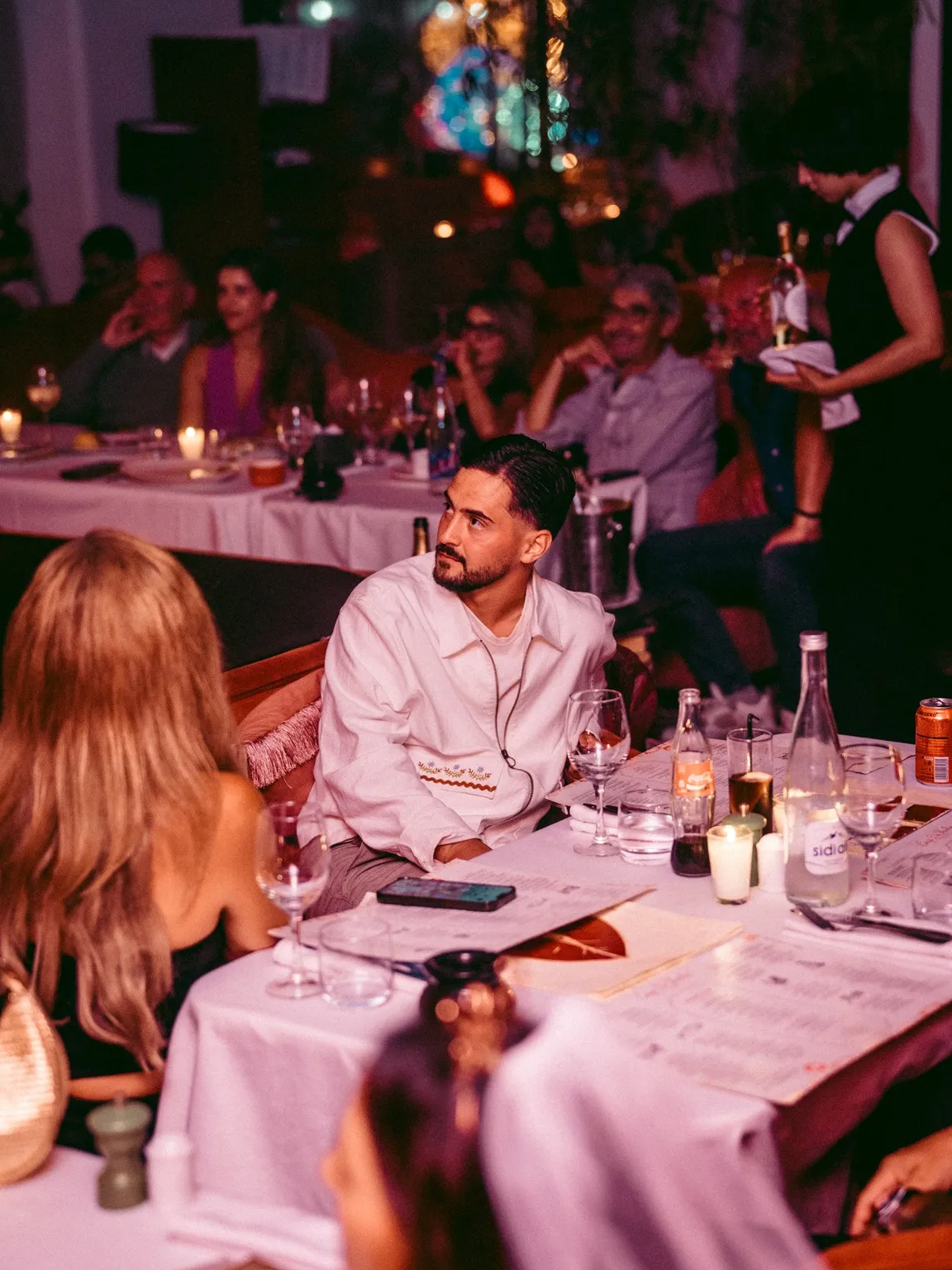 Guests along a candlelit table at Coup de Foudre Agadir